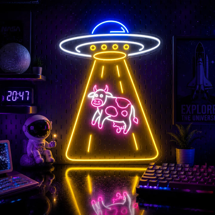 Retro UFO cow LED neon sign displayed in a cyberpunk gaming room with astronaut decor, RGB keyboard lighting, and futuristic space-themed ambiance.