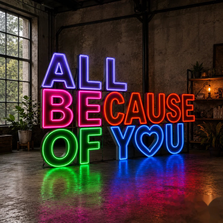 Large colorful RGB neon letter sign reading “All Because of You” displayed indoors with vibrant LED lighting for weddings, proposals, events, and romantic photo backdrops.