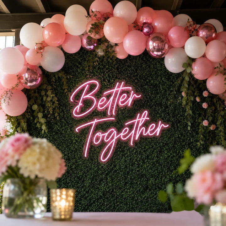Reception backdrop neon sign with bright pink LED script lettering and acrylic backing for chic wedding party and bridal celebration decor.