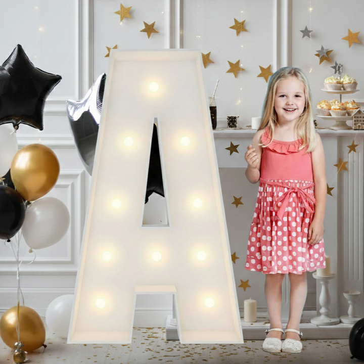 Large white LED marquee letter A illuminated for a party, with a smiling girl nearby.