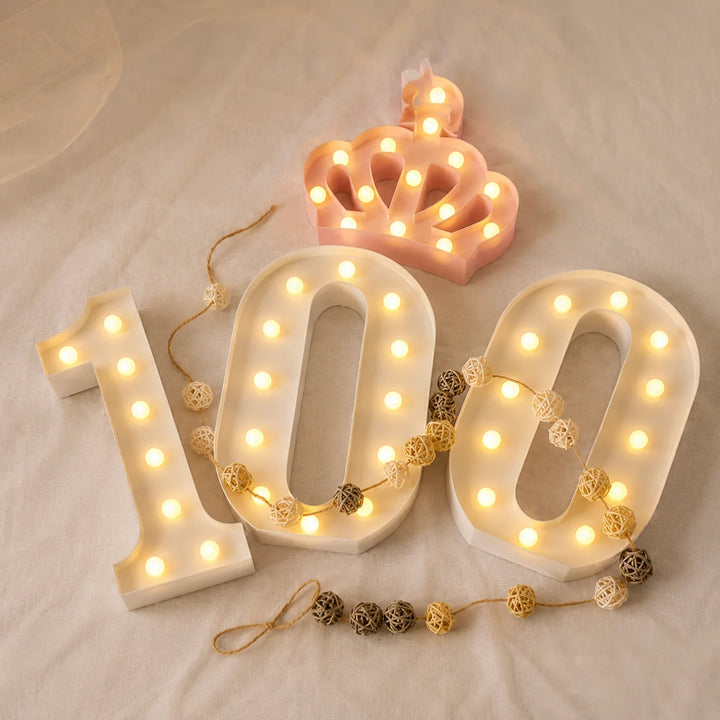 Decorative LED marquee number 100 sign paired with a pink illuminated crown, styled for 100th birthday celebrations, milestone anniversaries, event backdrops, and commemorative party decorations.