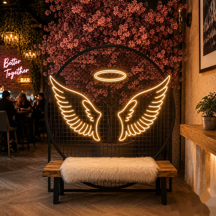 LED neon sign featuring glowing angel wings and halo design with warm white lighting for luxury photo booth and event backdrop decor.