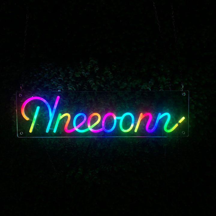 Custom rainbow gradient LED neon sign spelling nneeoonn mounted on a dark background