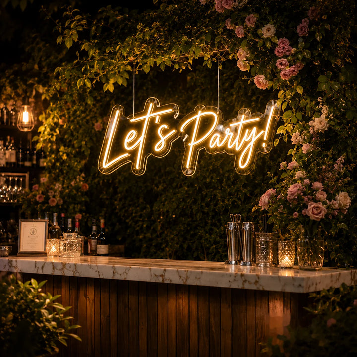 Custom LED neon sign with “Let’s Party” script lettering in warm white lighting for romantic garden cocktail bar decor.