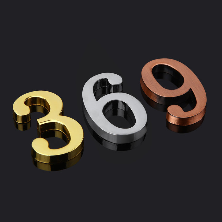 Three personalized house number address signs with the numbers 366, 369, and 386 displayed in large, bold, black and gold letters on a dark background.