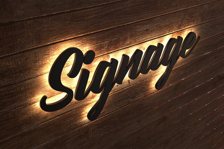 Custom black backlit LED sign spelling Signage mounted on a dark wooden wall