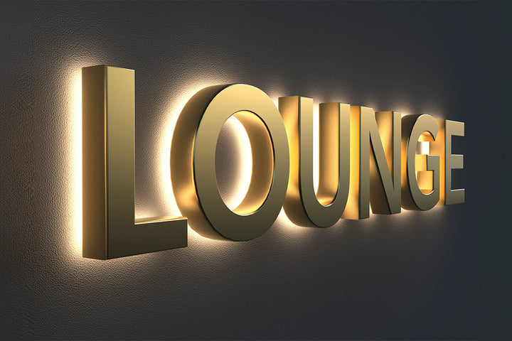 Custom gold 3D backlit LED sign spelling LOUNGE mounted on a dark wall
