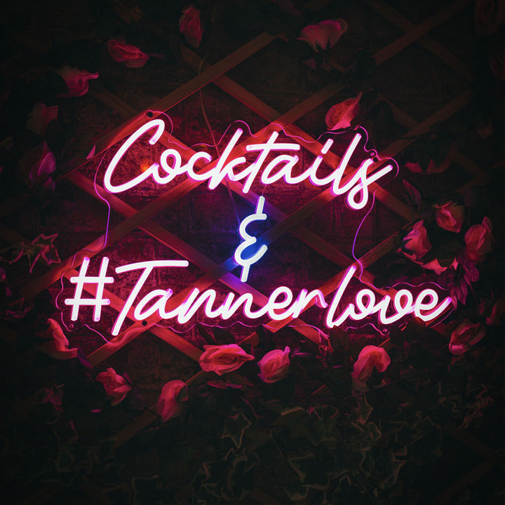 A custom neon sign with pink and blue lighting that reads &