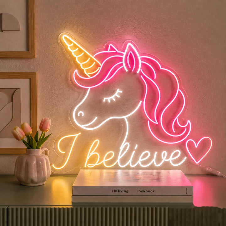 Fantasy unicorn LED wall sign with pink hair, golden horn, and “I believe” lettering, warm acrylic neon lighting for modern bedroom decor.